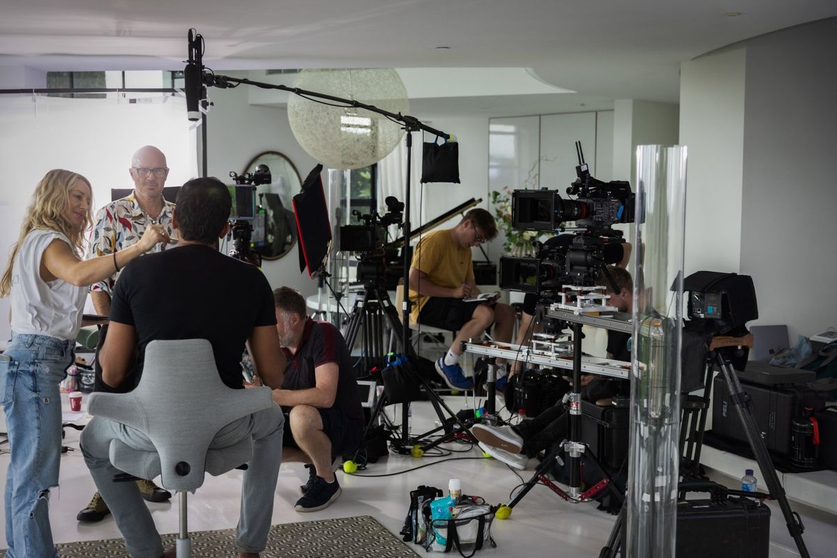 Crew setting up cameras and lights on a location set