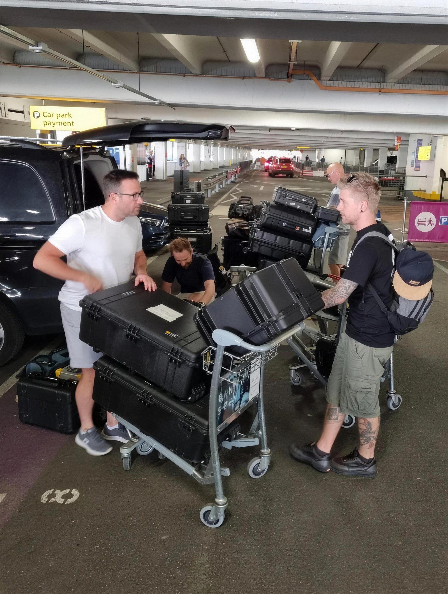 Crew loading flight cases into a vehicle