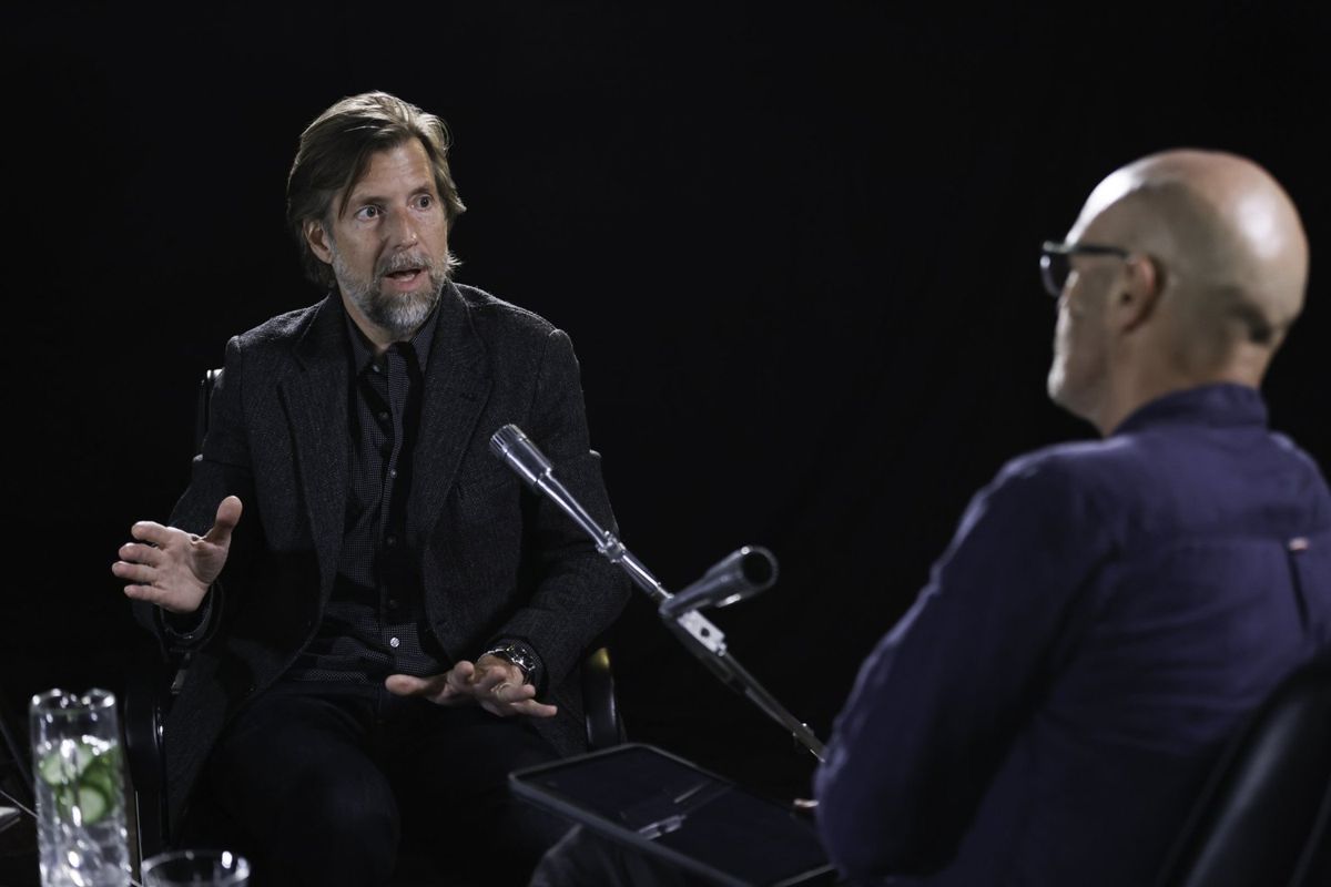Interview filmed against a black backdrop