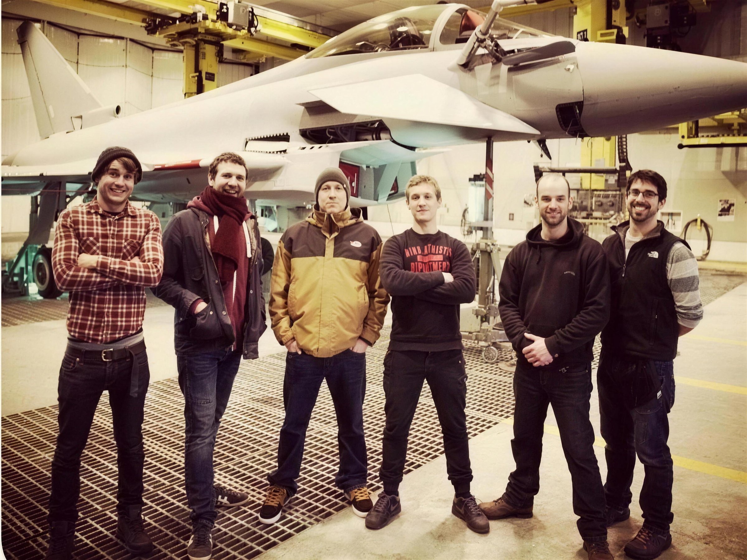Crewroom crew standing in an aircraft hangar